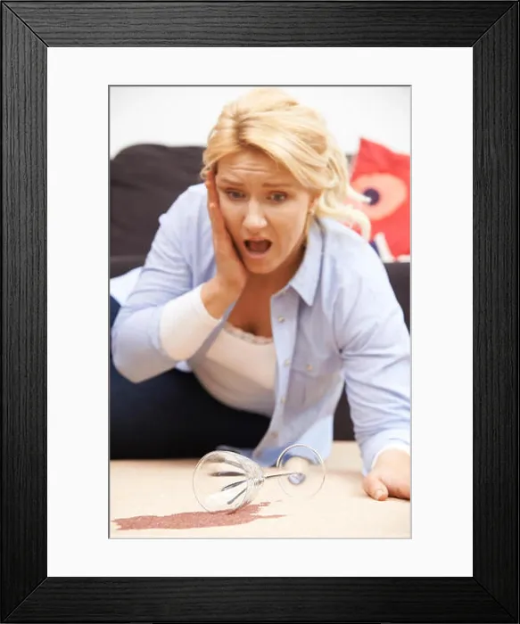 Framed Print : Woman Accidentally Spilling Red Wine On Carpet At Home Framed Print : Woman Accidentally Spilling Red Wine On Carpet At Home