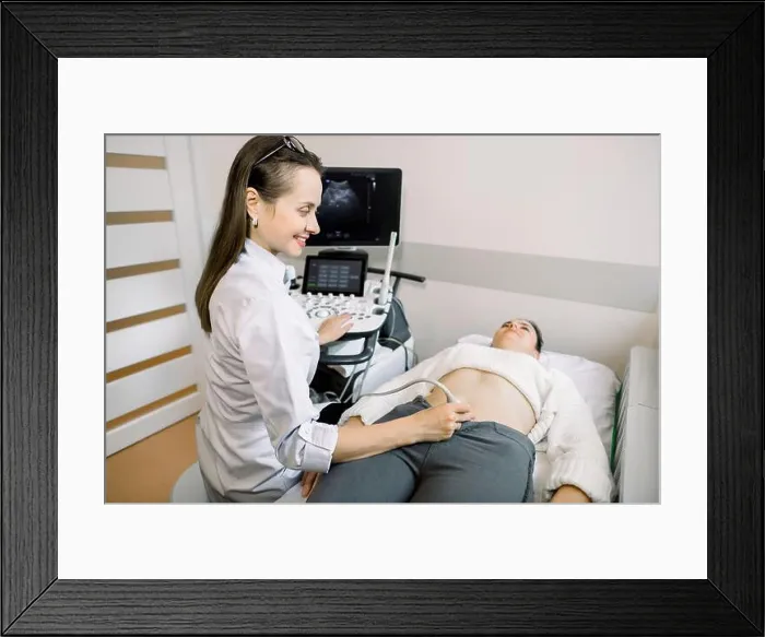 Framed Print : Female doctor performs ultrasound examination of pelvic organs of her female patient for diagnostic early pregnancy Framed Print : Female doctor performs ultrasound examination of pelvic organs of her female patient for diagnostic early pregnancy