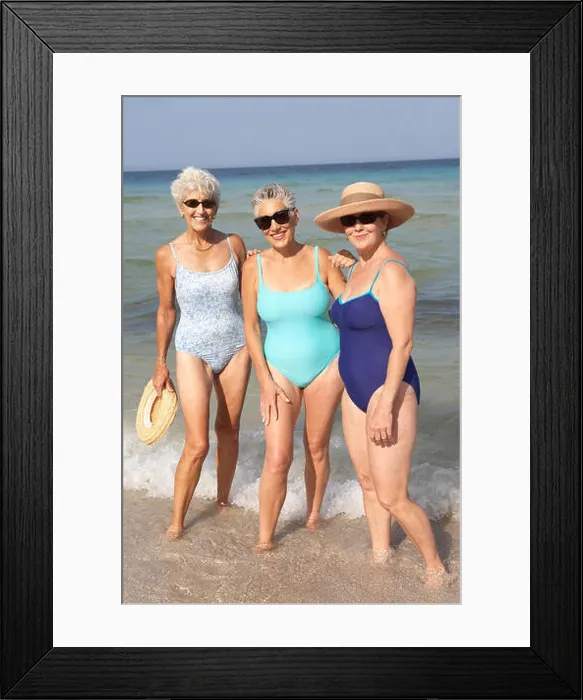 Framed Print : Senior women standing in waves on beach Framed Print : Senior women standing in waves on beach