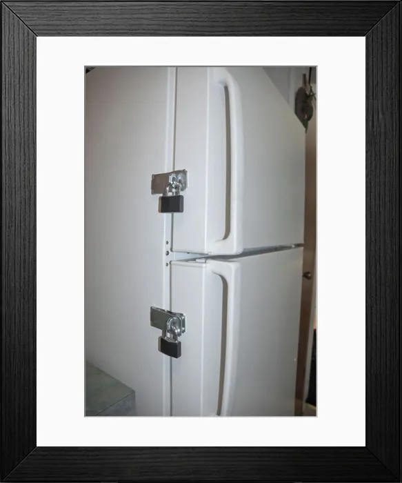 Framed Print : locks on a refrigerator door to keep someone on their diet Framed Print : locks on a refrigerator door to keep someone on their diet