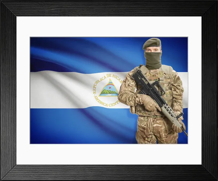 Framed Print : Soldier holding machine gun with national flag on background - Nicaragua Framed Print : Soldier holding machine gun with national flag on background - Nicaragua