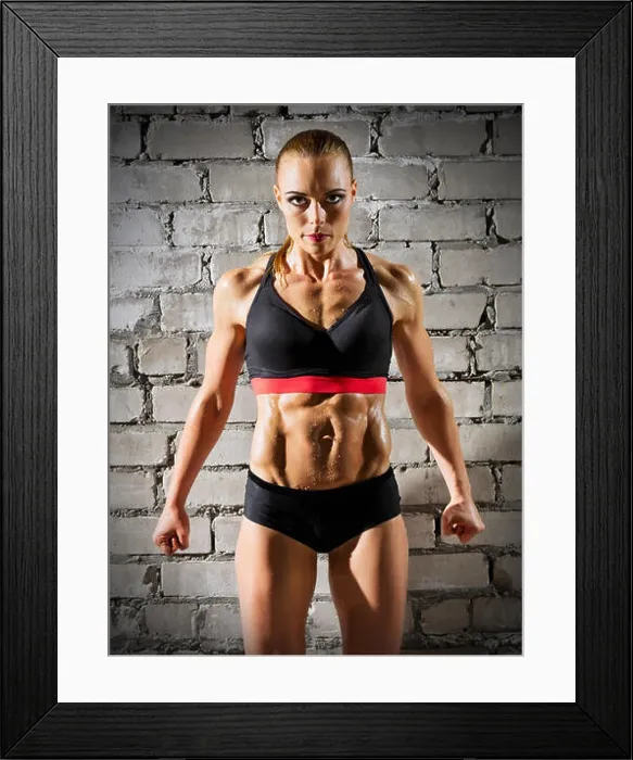 Framed Print : Muscular woman on grey brick wall (normal version) Framed Print : Muscular woman on grey brick wall (normal version)