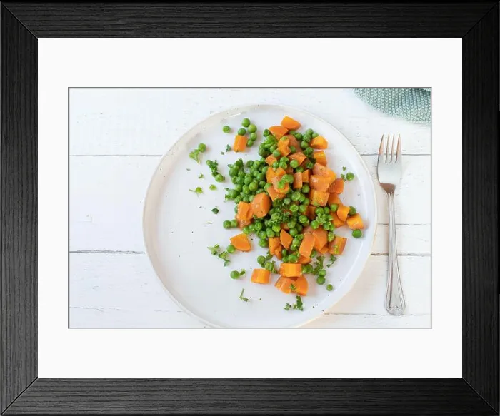 Framed Print : Buttered peas and carrots on a plate isolated on a white plate on light wooden background with fork. Flat lay Framed Print : Buttered peas and carrots on a plate isolated on a white plate on light wooden background with fork. Flat lay