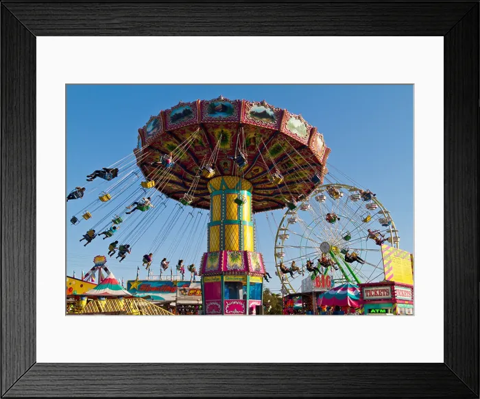 Framed Print : People spinning in air hanging in chairs on a carnival ride Framed Print : People spinning in air hanging in chairs on a carnival ride