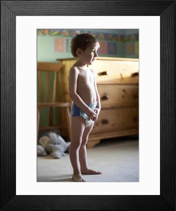 Framed Print : Young boy child standing in his bedroom wearing a pull up nappy CJWH Framed Print : Young boy child standing in his bedroom wearing a pull up nappy CJWH