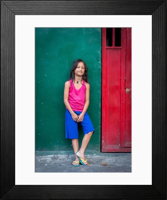 Framed Print : A pretty young Filipino girl poses and smiles for my camera in the old walled city of Intramuros Framed Print : A pretty young Filipino girl poses and smiles for my camera in the old walled city of Intramuros