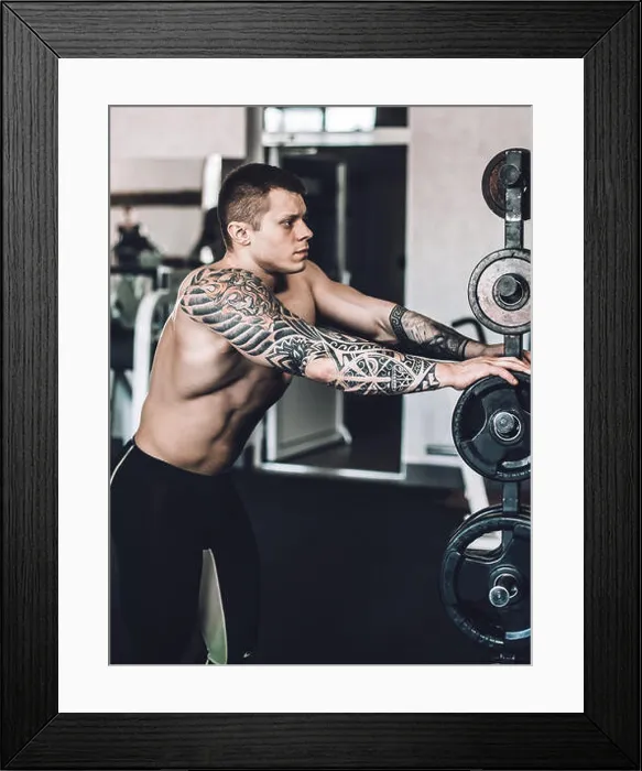 Framed Print : close up. male bodybuilder with a tattoo on his arm standing in the gym Framed Print : close up. male bodybuilder with a tattoo on his arm standing in the gym