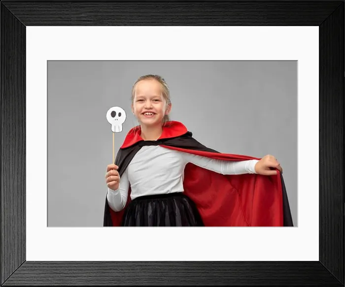 Framed Print : girl in costume of dracula with cape on halloween Framed Print : girl in costume of dracula with cape on halloween