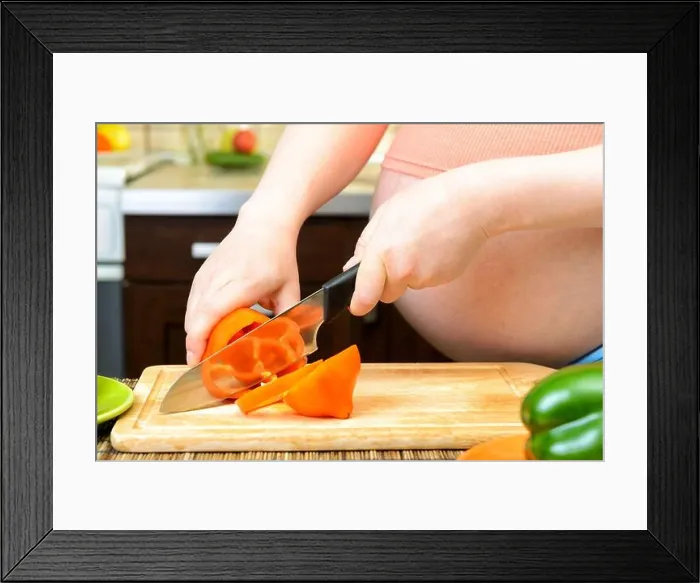 Framed Print : Pregnant woman preparing a healthy meal in the kitchen Framed Print : Pregnant woman preparing a healthy meal in the kitchen