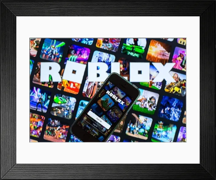 Framed Print : In this photo illustration, the Roblox app seen displayed on a smartphone screen and a Roblox logo in the background Framed Print : In this photo illustration, the Roblox app seen displayed on a smartphone screen and a Roblox logo in the background