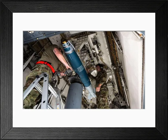 Framed Print : U.S. Airmen assigned to the 34th Expeditionary Bomb Squadron load a joint direct attack munition at Andersen Air Force