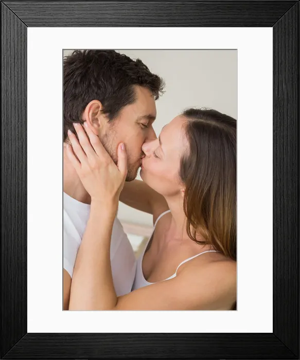 Framed Print : Loving young couple kissing at home Framed Print : Loving young couple kissing at home