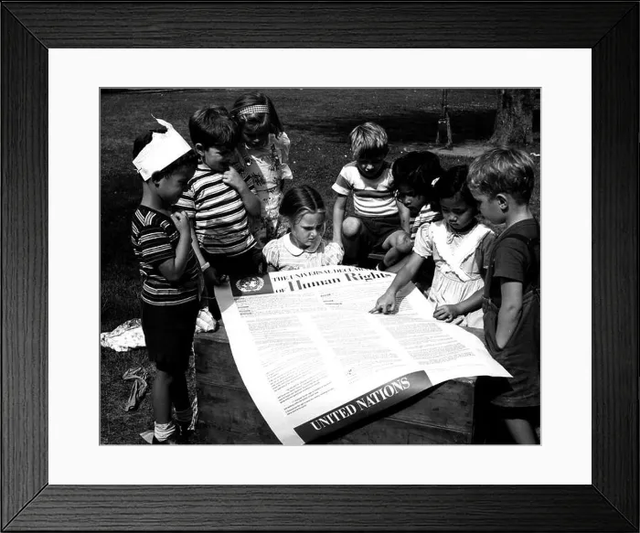 Framed Print : Photograph taken of children of the United Nations International Nursery School looking at a poster of the Universal