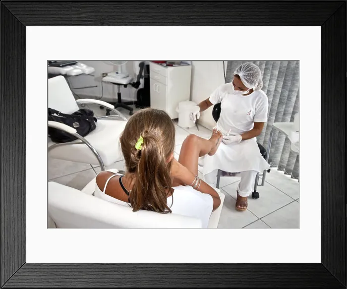 Framed Print : Manicure and pedicure nails making a customer Framed Print : Manicure and pedicure nails making a customer