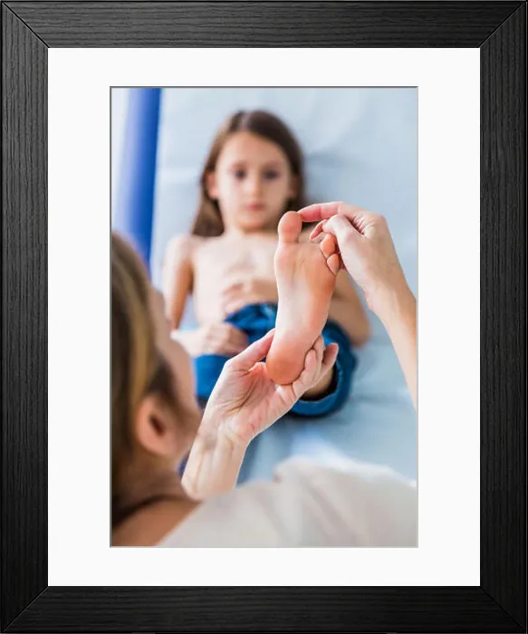 Framed Print : Doctor examining girl's foot Framed Print : Doctor examining girl's foot