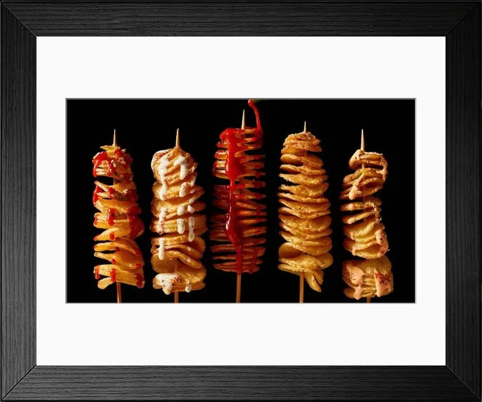 Framed Print : Top view layout of yummy crispy deep fried tornado potatoes on skewers with mayo and ketchup on black background Framed Print : Top view layout of yummy crispy deep fried tornado potatoes on skewers with mayo and ketchup on black background