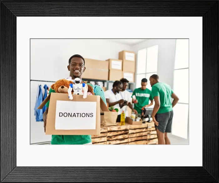 Framed Print : Group of young african american volunteers working at charity center Framed Print : Group of young african american volunteers working at charity center