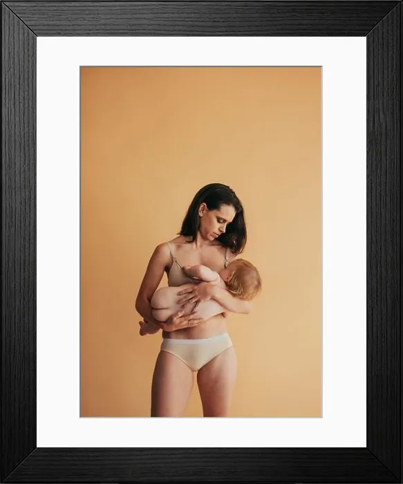 Framed Print : Postpartum mother breastfeeding her baby. Mom nursing baby Framed Print : Postpartum mother breastfeeding her baby. Mom nursing baby