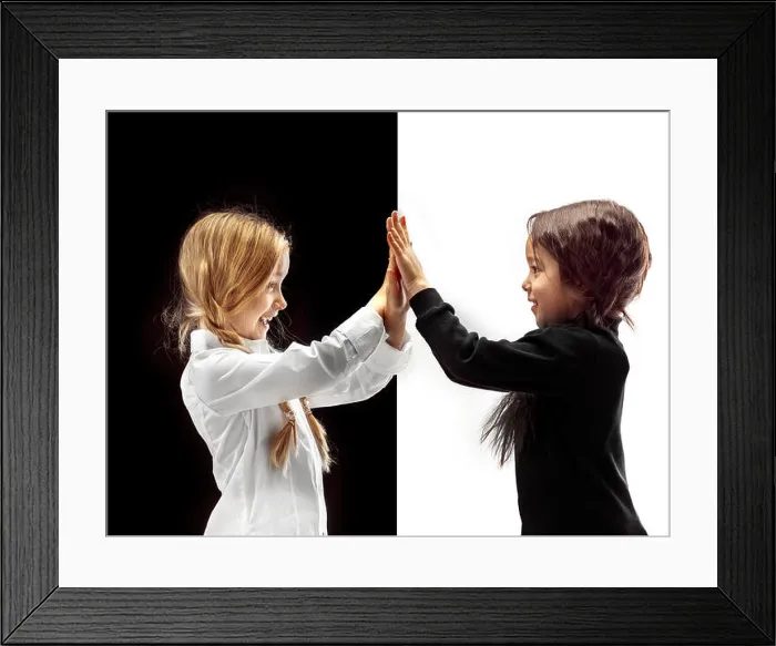 Framed Print : Hand shake and high five. The portrait of two happy holding hands girls on a white and black studio background Framed Print : Hand shake and high five. The portrait of two happy holding hands girls on a white and black studio background