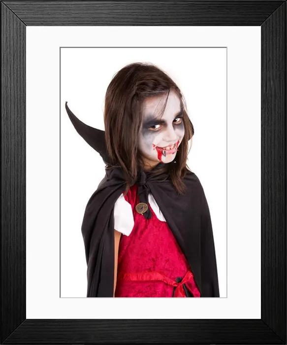 Framed Print : Girl with face-paint and Halloween vampire costume isolated in white Framed Print : Girl with face-paint and Halloween vampire costume isolated in white