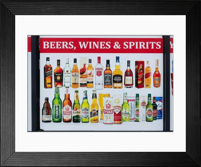 Framed Print : Advertising poster for beers, wines and spirits in the window of a convenience store, UK Framed Print : Advertising poster for beers, wines and spirits in the window of a convenience store, UK