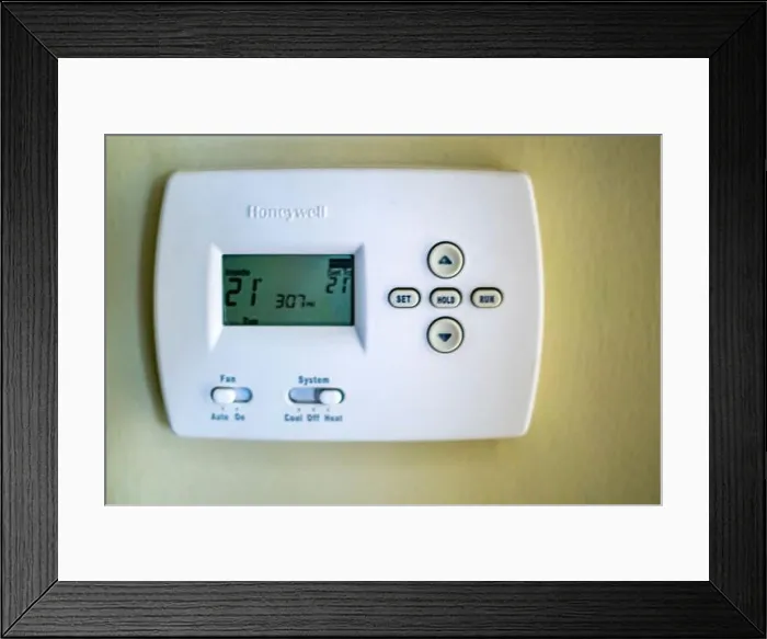 Framed Print : A honeywell thermostat for home central heating fixed to a wall Framed Print : A honeywell thermostat for home central heating fixed to a wall