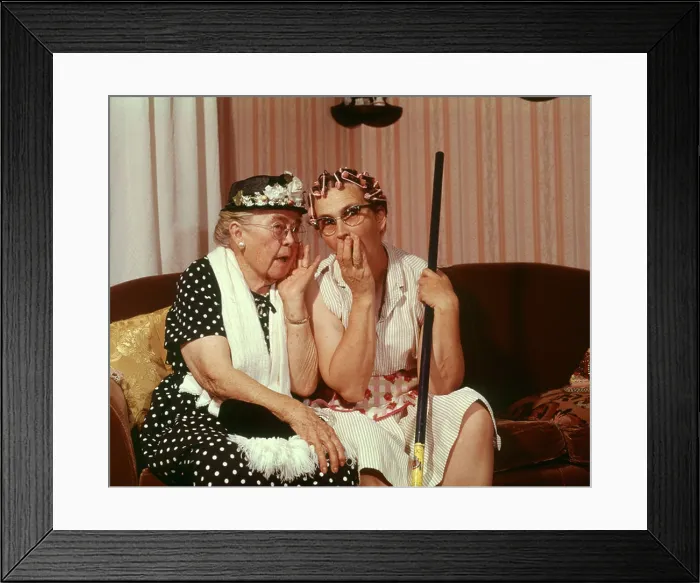 Framed Print : 1960s TWO SENIOR OLDER WOMEN SITTING ON SOFA GOSSIPING