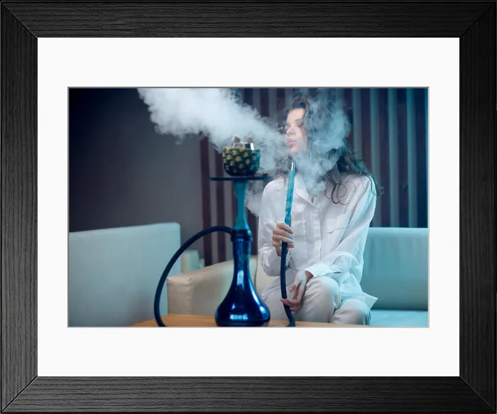 Framed Print : Young beautiful woman smokes hookah on tobacco with pineapple bowl Framed Print : Young beautiful woman smokes hookah on tobacco with pineapple bowl