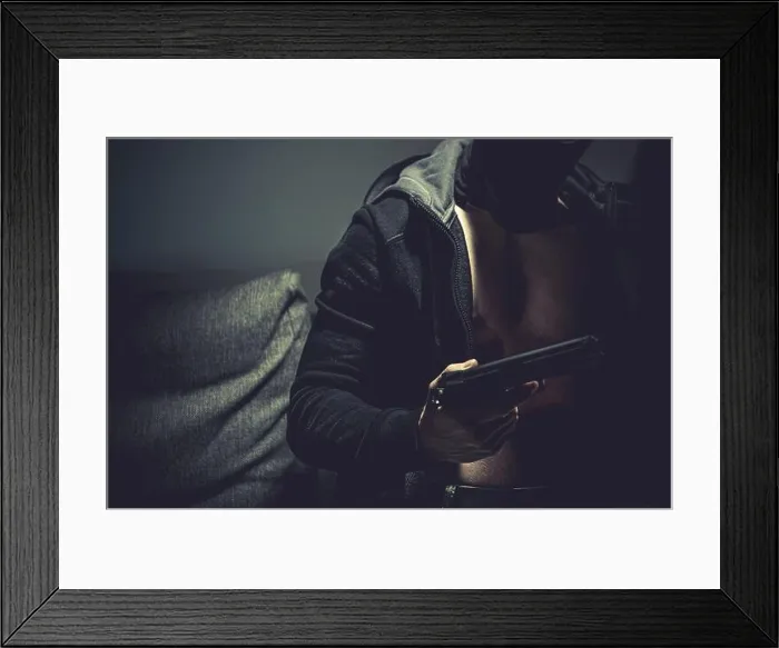 Framed Print : Caucasian Gangster Wearing Black Hoodie with Handgun in a Hand Close Up Photo. Illegal Activities Theme Framed Print : Caucasian Gangster Wearing Black Hoodie with Handgun in a Hand Close Up Photo. Illegal Activities Theme