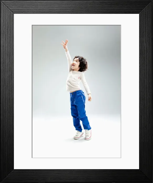 Framed Print : a boy jumping to reach something Framed Print : a boy jumping to reach something