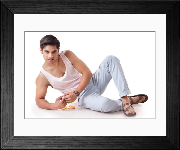 Framed Print : Portrait of a young man in white vest sitting on the floor Framed Print : Portrait of a young man in white vest sitting on the floor
