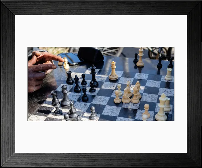 Framed Print : Chess player points at playing board with 2 fingers during a game at the southwest corner of Washington Square Park Framed Print : Chess player points at playing board with 2 fingers during a game at the southwest corner of Washington Square Park