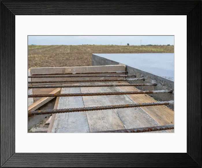 Framed Print : Reinforcing bars sticking out of reinforced concrete slab Framed Print : Reinforcing bars sticking out of reinforced concrete slab