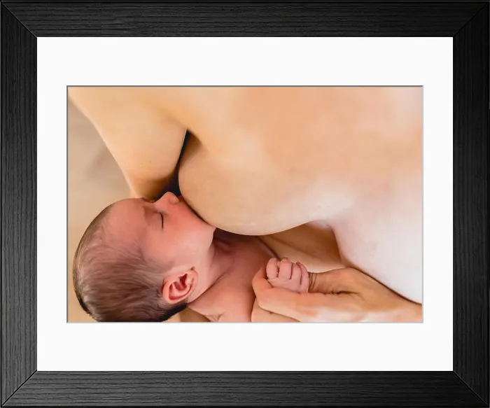 Framed Print : Newborn baby sucking breastfeeding from his mother's breast Framed Print : Newborn baby sucking breastfeeding from his mother's breast