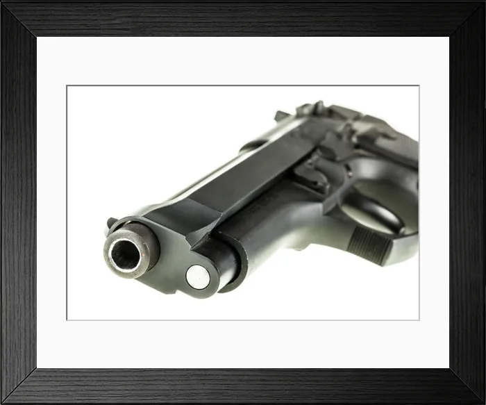 Framed Print : detail of a black 9mm pistol barrel isolated over a white background Framed Print : detail of a black 9mm pistol barrel isolated over a white background