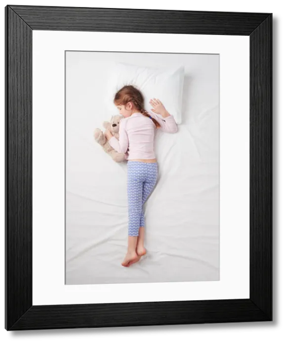 Framed Print : Top view of little cute girl sleeping with teddy bear Framed Print : Top view of little cute girl sleeping with teddy bear