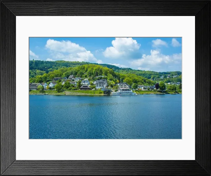 Framed Print : Village Rurberg at Eifel National Park, Germany. Scenic view of lake Rursee and houses in the background
