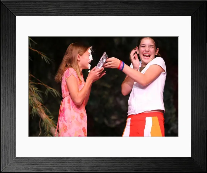Framed Print : Two young girls giggling after one hits the other with a pie in the face Framed Print : Two young girls giggling after one hits the other with a pie in the face