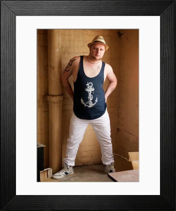 Framed Print : Gay man wearing white trousers and blue vest indoors Framed Print : Gay man wearing white trousers and blue vest indoors