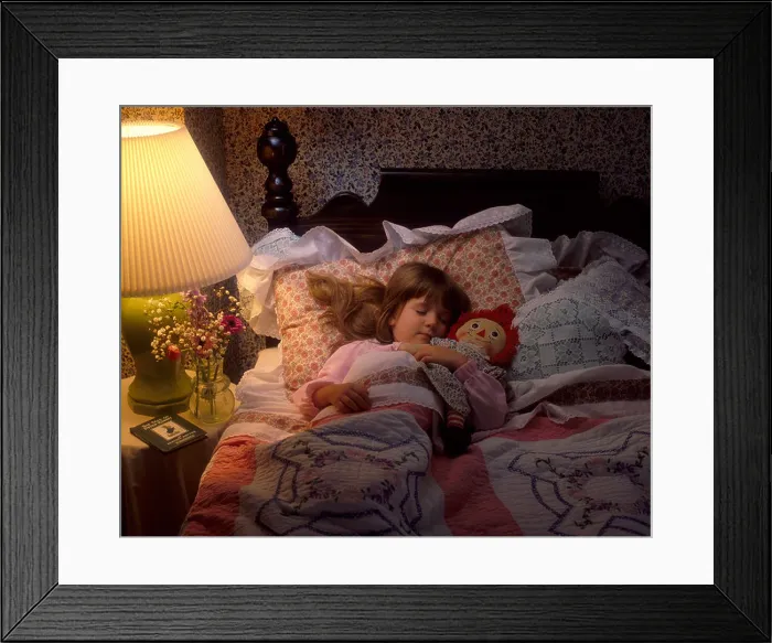 Framed Print : Little girl sleeping in bed with Raggedy Ann doll Framed Print : Little girl sleeping in bed with Raggedy Ann doll