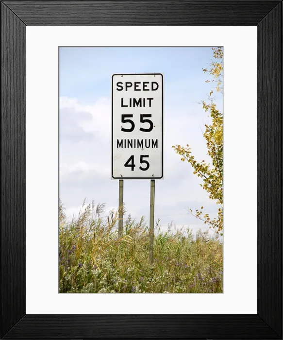 Framed Print : Traffic sign on the interstate freeway showing maximum and minimum speed limits on the same sign Framed Print : Traffic sign on the interstate freeway showing maximum and minimum speed limits on the same sign