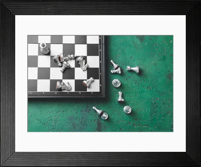 Framed Print : Chess pieces with game board on color background Framed Print : Chess pieces with game board on color background