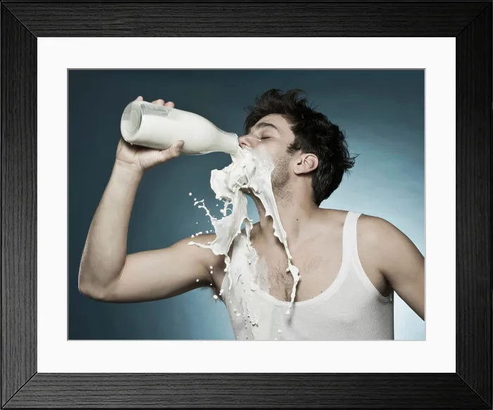 Framed Print : Caucasian man drinking milk and spilling it Framed Print : Caucasian man drinking milk and spilling it