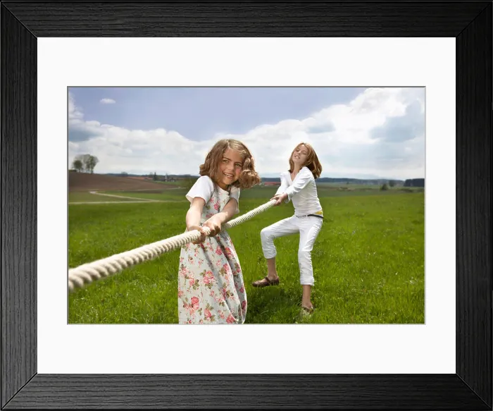 Framed Print : Children pulling a rope in countryside Framed Print : Children pulling a rope in countryside