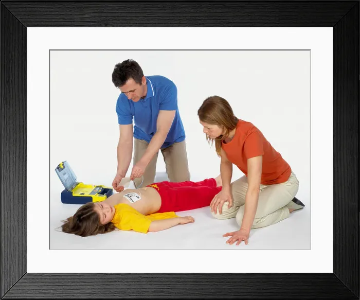 Framed Print : First aid, using paediatric defibrillator Framed Print : First aid, using paediatric defibrillator