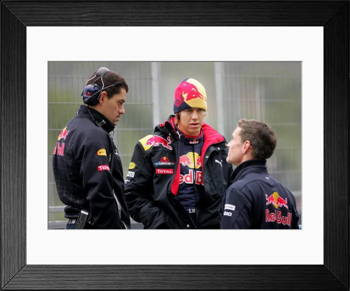 Framed Print : German Formula One driver Sebastian Vettel of Red Bull (C) talks to race engineer Guillaume Rocquelin (L) Framed Print : German Formula One driver Sebastian Vettel of Red Bull (C) talks to race engineer Guillaume Rocquelin (L)