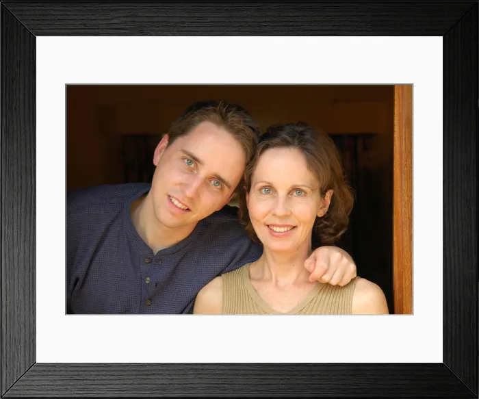 Framed Print : 45 year old mother enjoying a moment with her 21 year old son Framed Print : 45 year old mother enjoying a moment with her 21 year old son