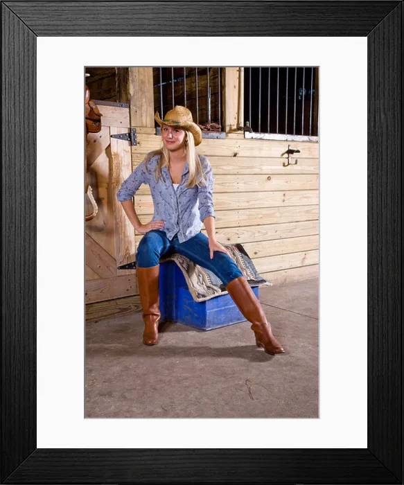 Framed Print : Teenage girl in stable with saddle wearing cowboy hat and boots Framed Print : Teenage girl in stable with saddle wearing cowboy hat and boots