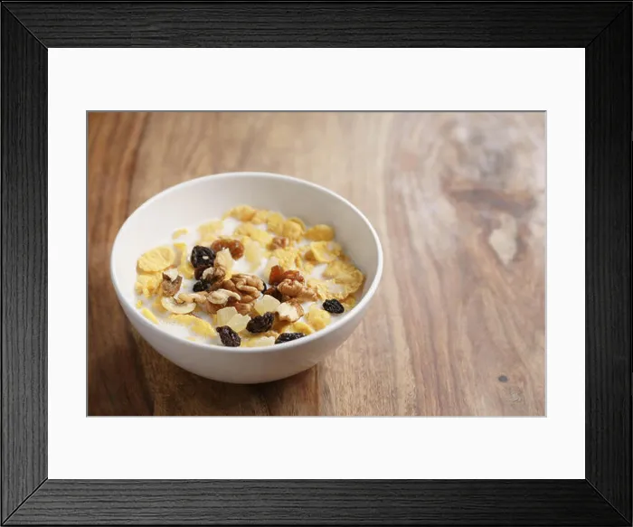 Framed Print : corn flakes with fruits and nuts in white bowl on wood table with copy space Framed Print : corn flakes with fruits and nuts in white bowl on wood table with copy space