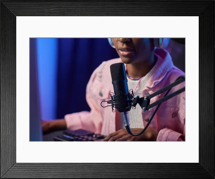Framed Print : Close up of African American girl speaking to microphone while playing video games online at night copy space Framed Print : Close up of African American girl speaking to microphone while playing video games online at night copy space